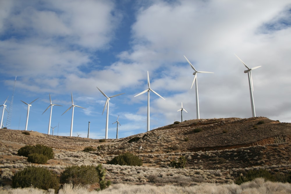 white wind turbines during daytime