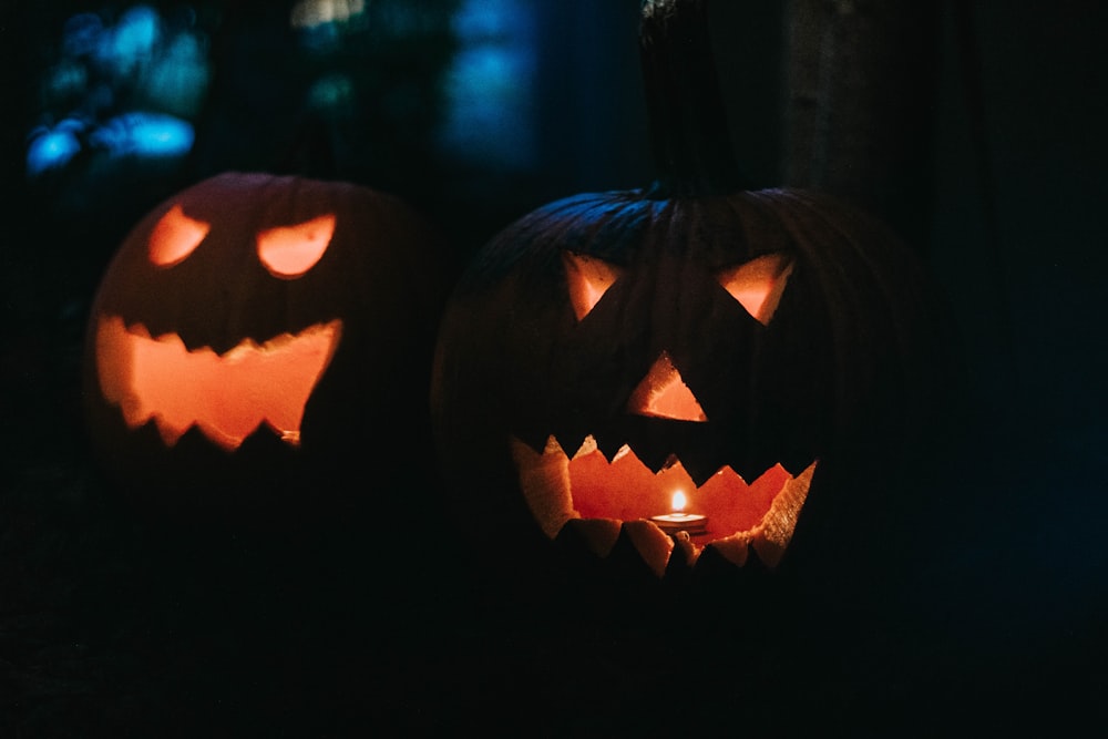 two lighted jack-o'-lanterns