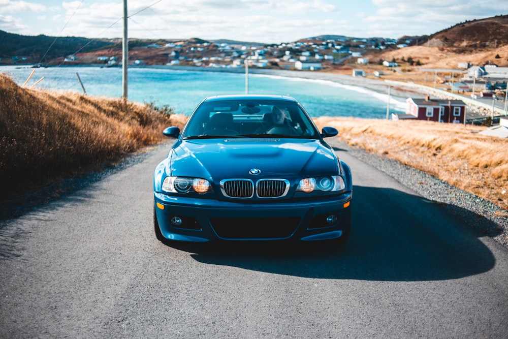 gray BMW car parked in the middle of highway