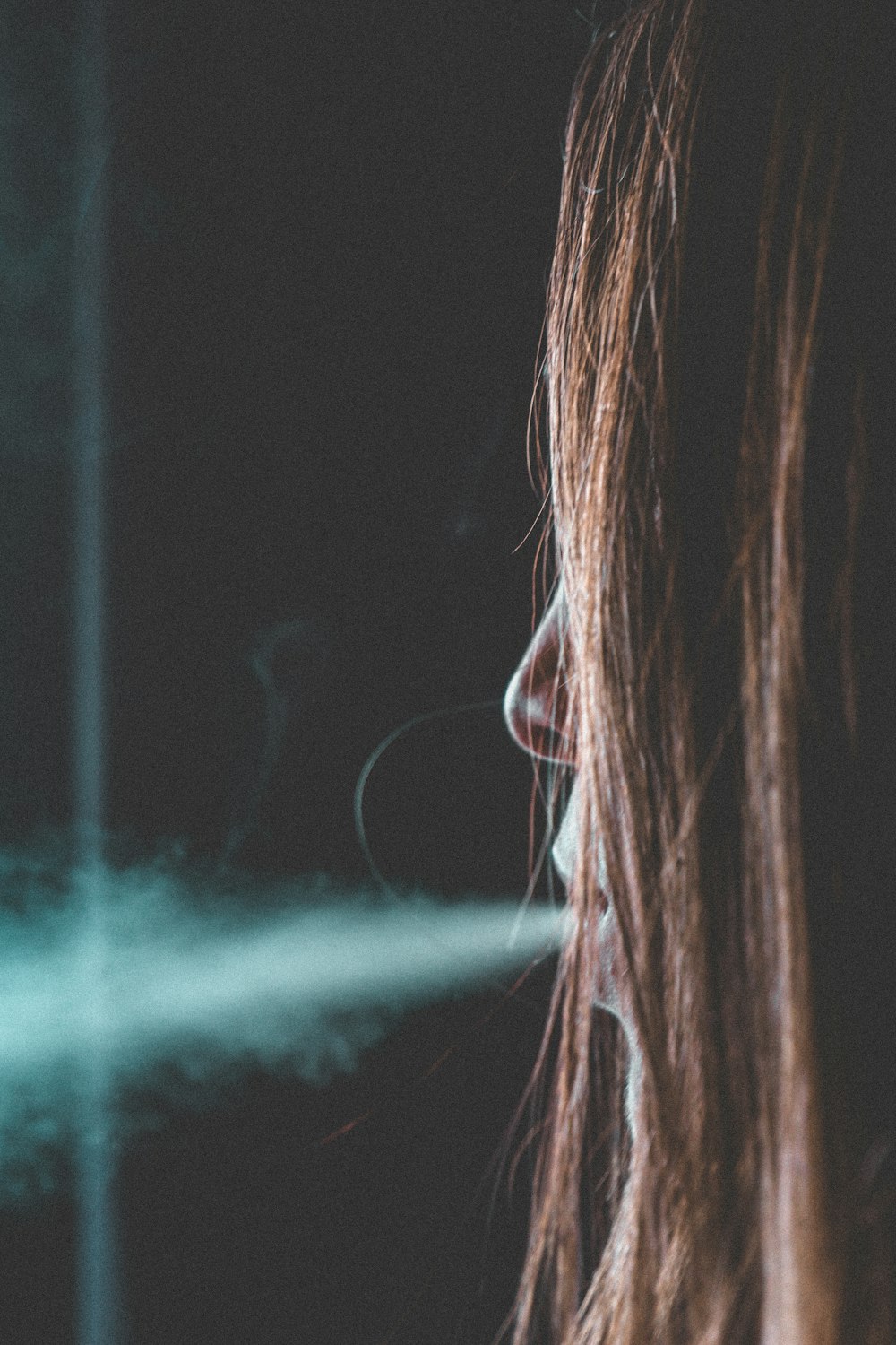 woman releasing smoke from mouth