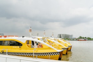 Aerial view of multiple water taxis operating on a river during flood season.