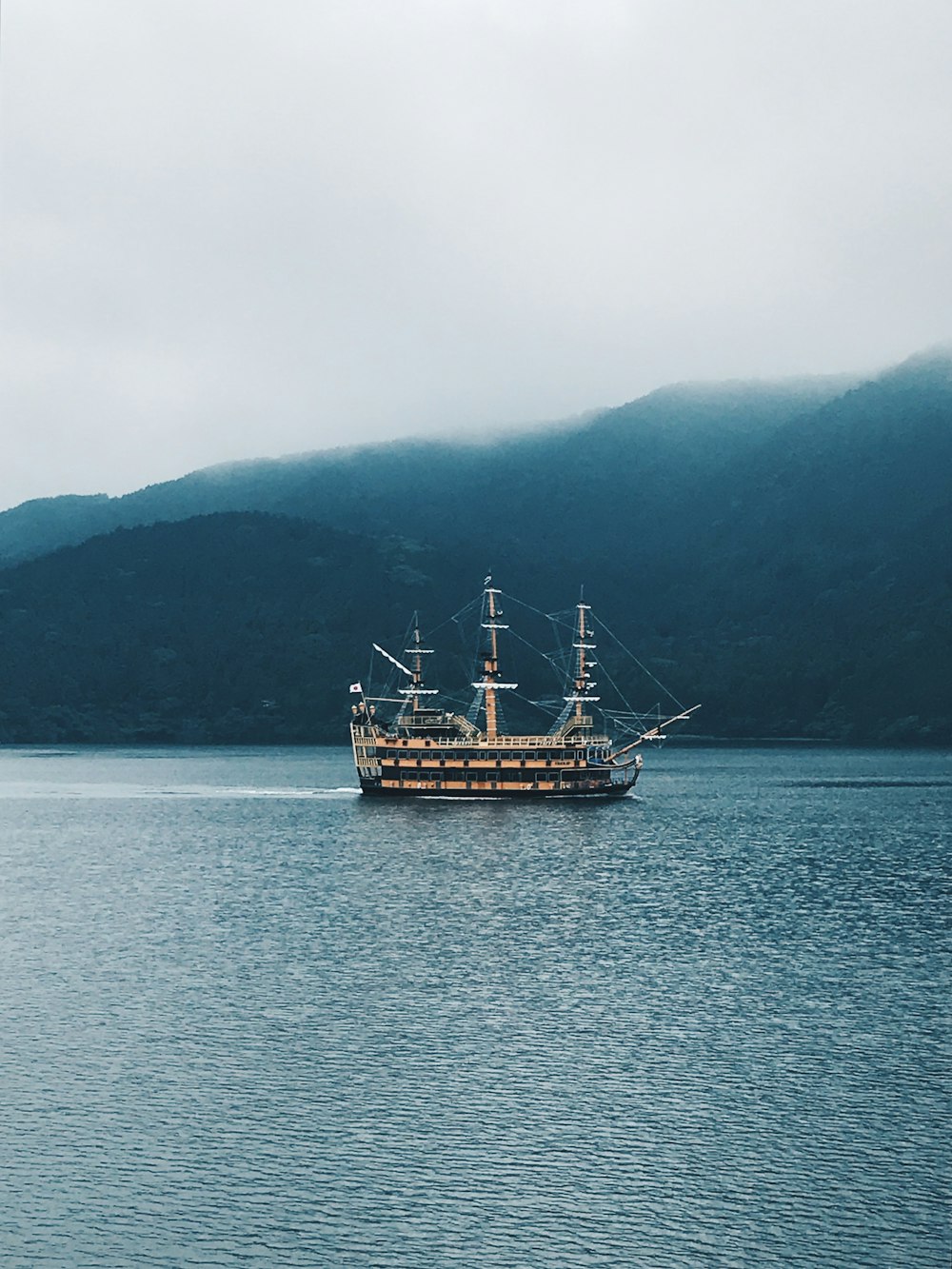 boat on body of water facing mountains