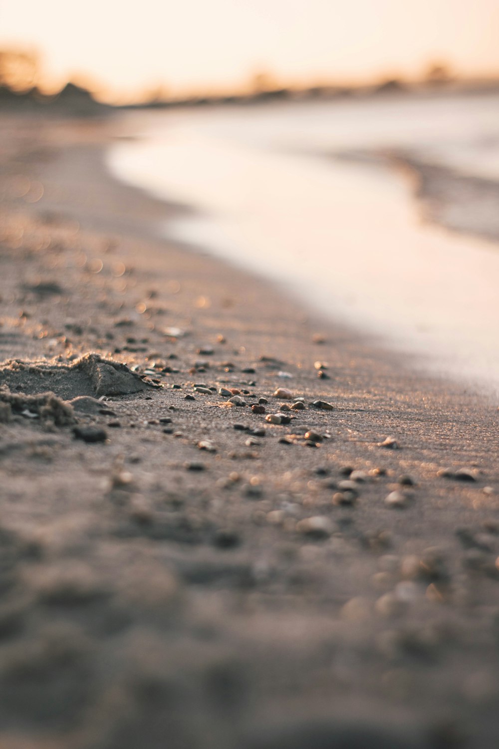 a close up of sand and water on a beach