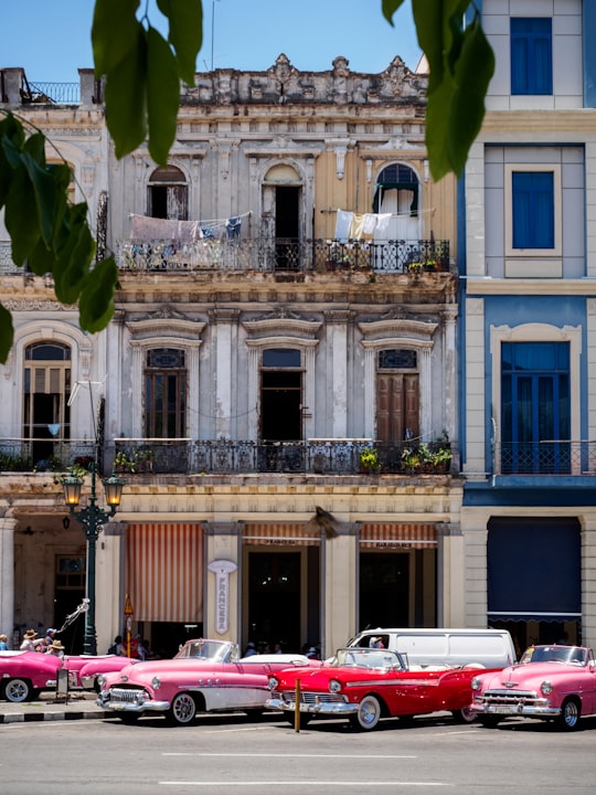vehicle parked beside concrete buildings in Central Park Cuba