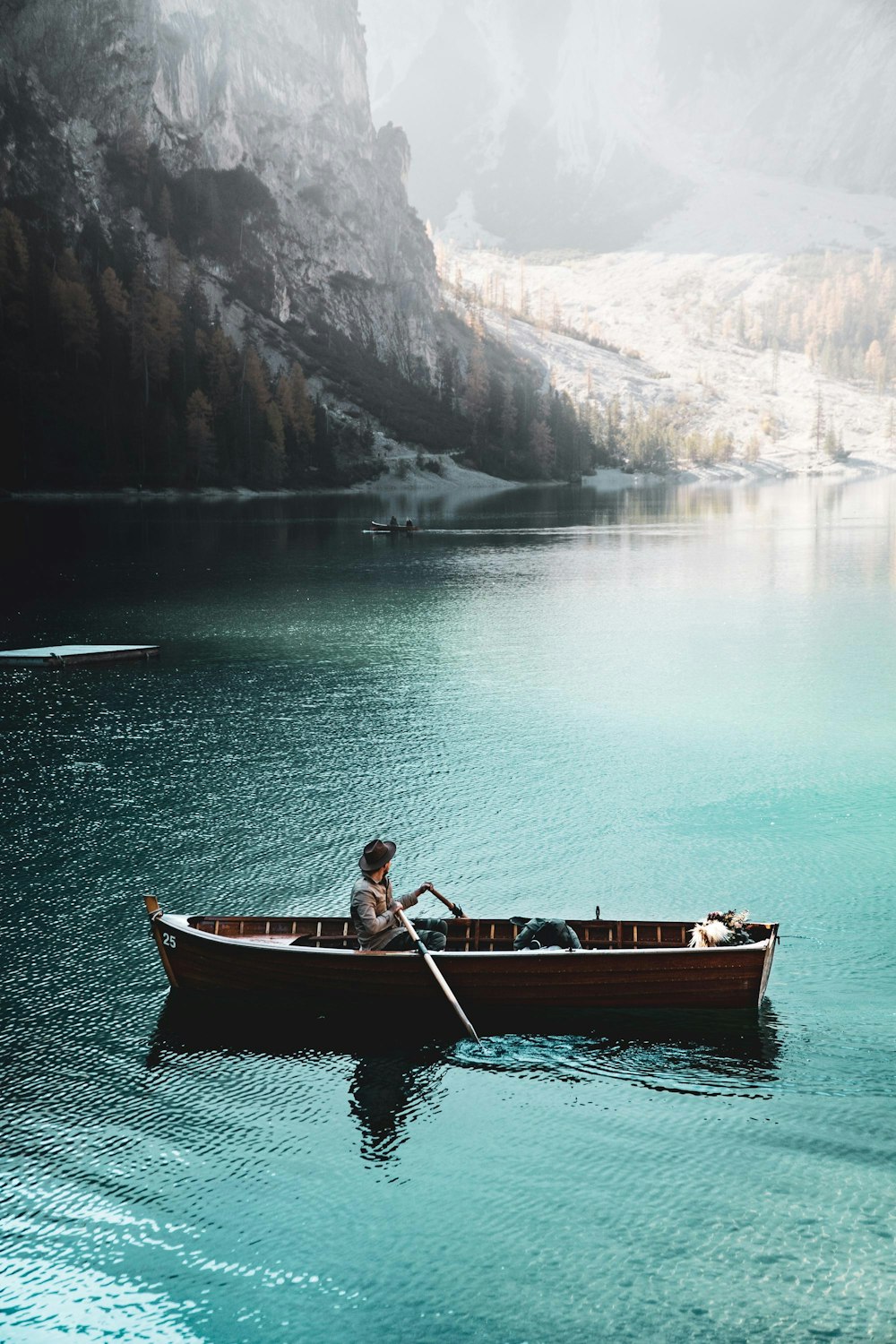 person on boat near mountain range