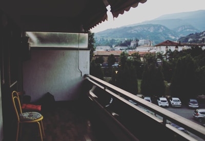 Balcony with yellow chairs overlooking city skyline