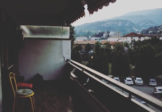 Balcony with yellow chairs overlooking city skyline