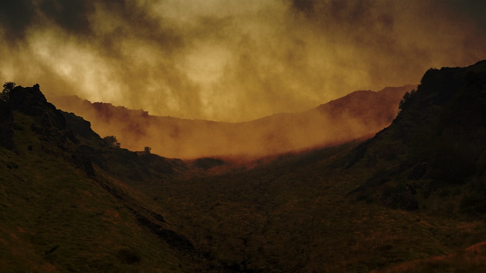 a view of a mountain range with clouds in the sky