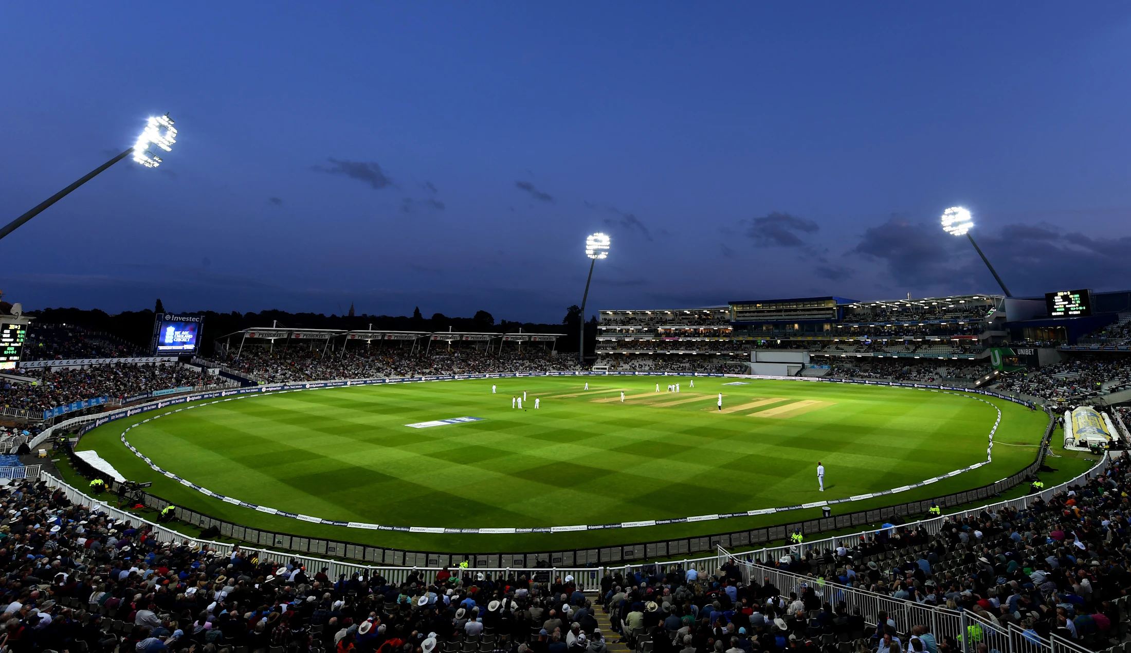 A packed stadium under event lights