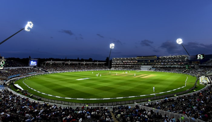 The Gabba oval ground under blue sky with Brisbane skyline beyond
