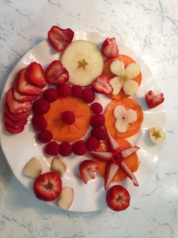 An assortment of fruits arranged beautifully on a plate.