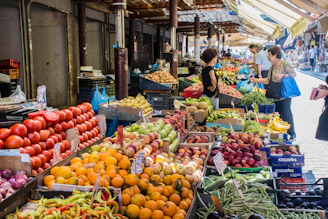 A bustling South Florida farmers market with colorful fruits, vegetables, and smiling vendors.