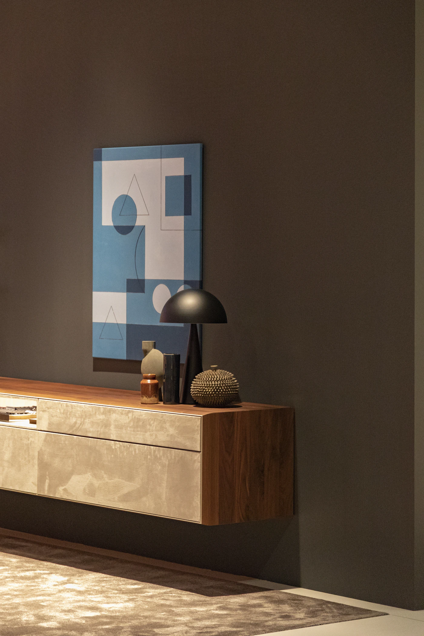 A table lamp resting on an antique wooden sideboard