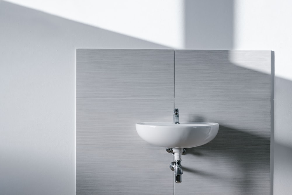 white sink mounted on wall