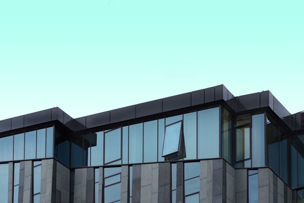 gray and blue curtain wall building under blue sky