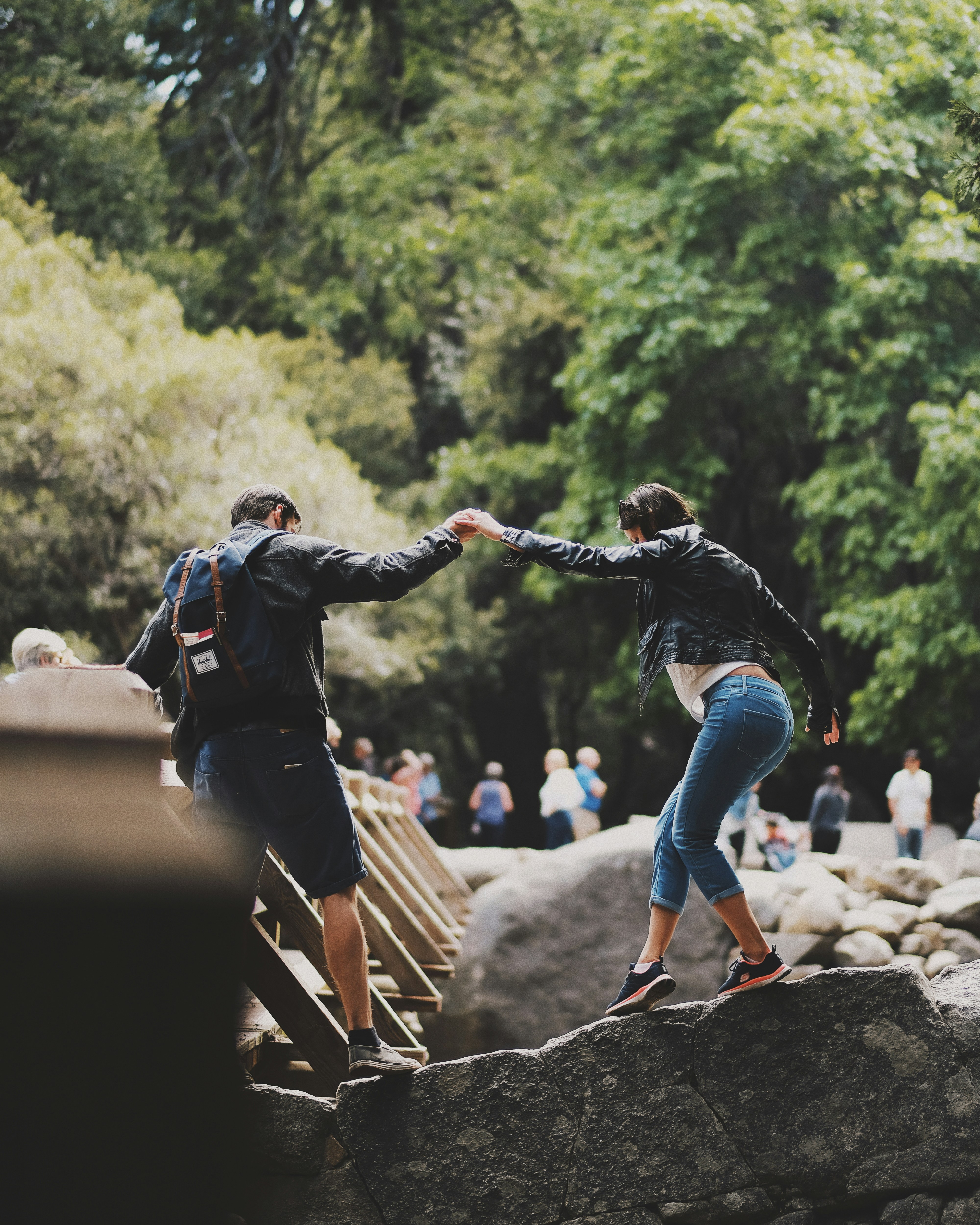 man and woman standing on rock
