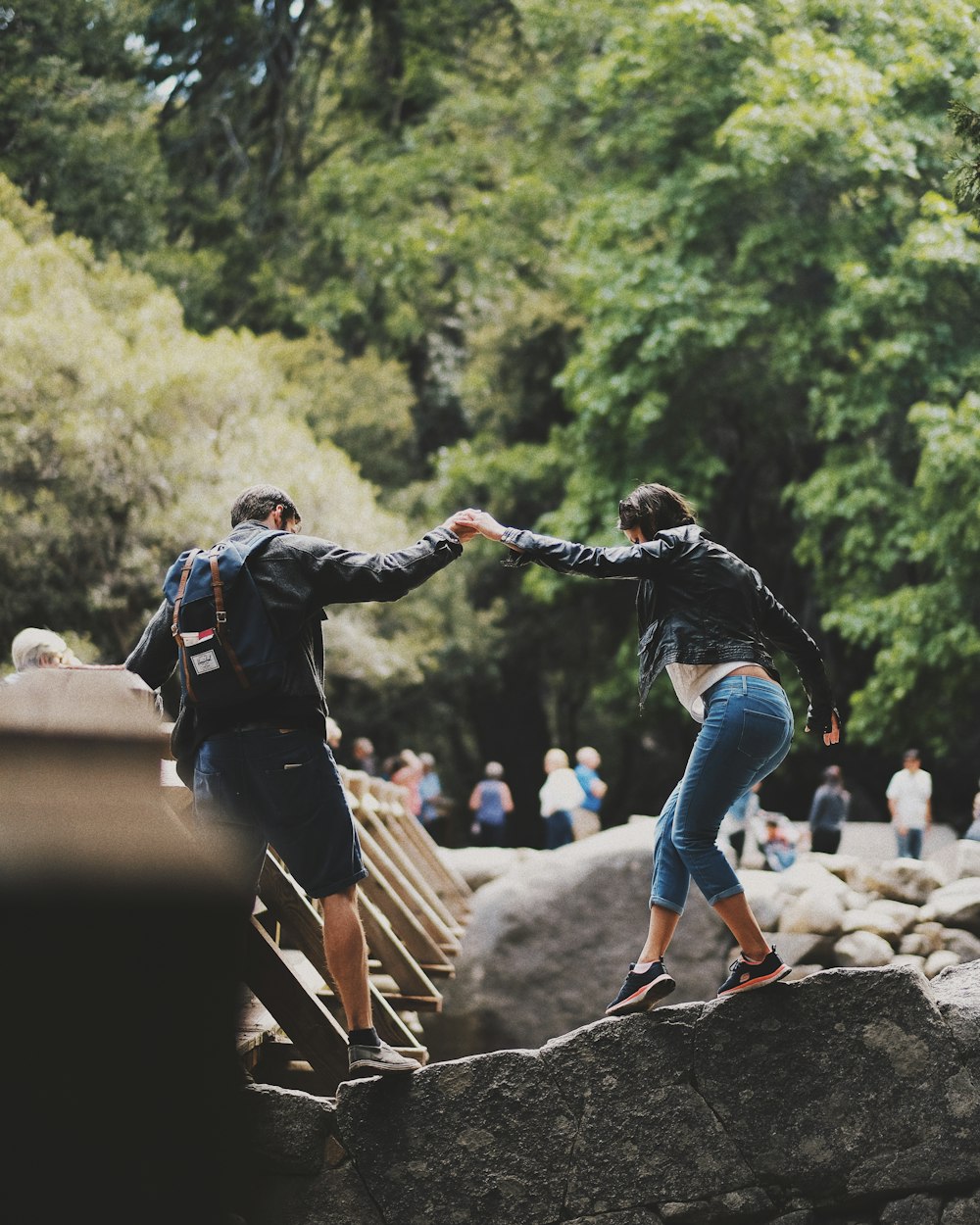 man and woman standing on rock