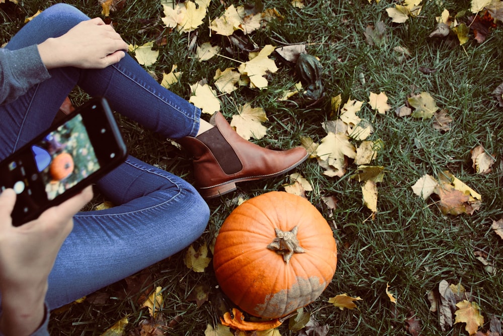 person showing red squash on phone