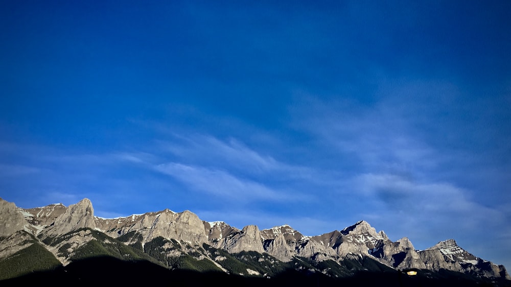 white clouds above gray rock formations