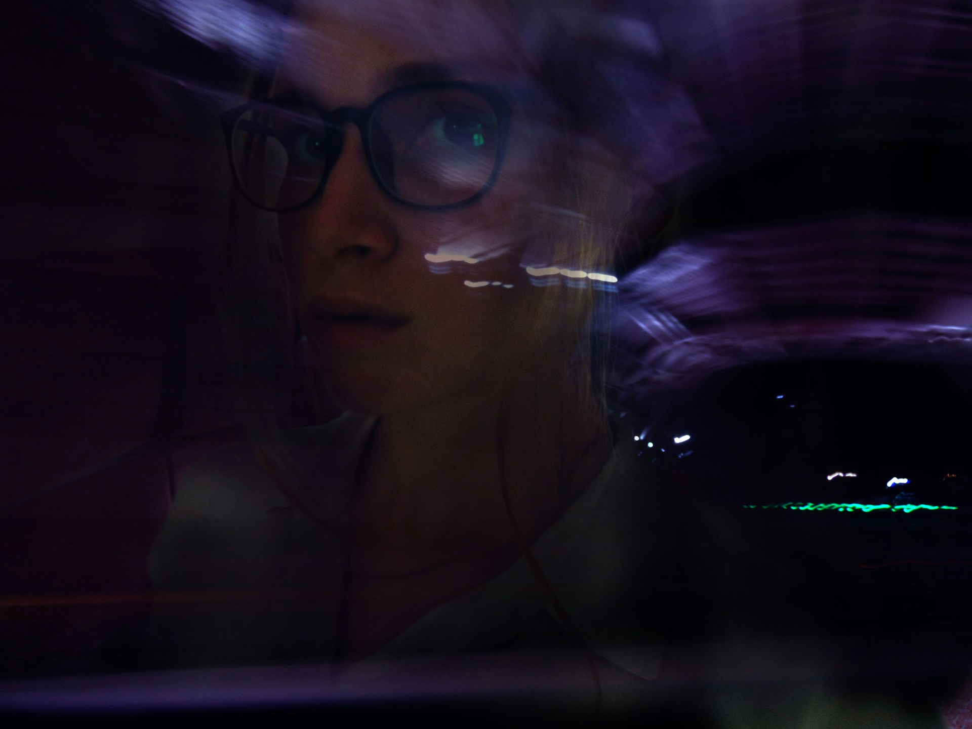 A close-up portrait blending natural photography with surreal light trails and particle effects swirling around the subject.