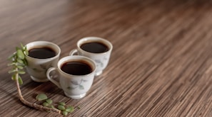 Freshly brewed coffee cups lined up on the cart’s wooden surface, with soft blush and sage green accents nearby