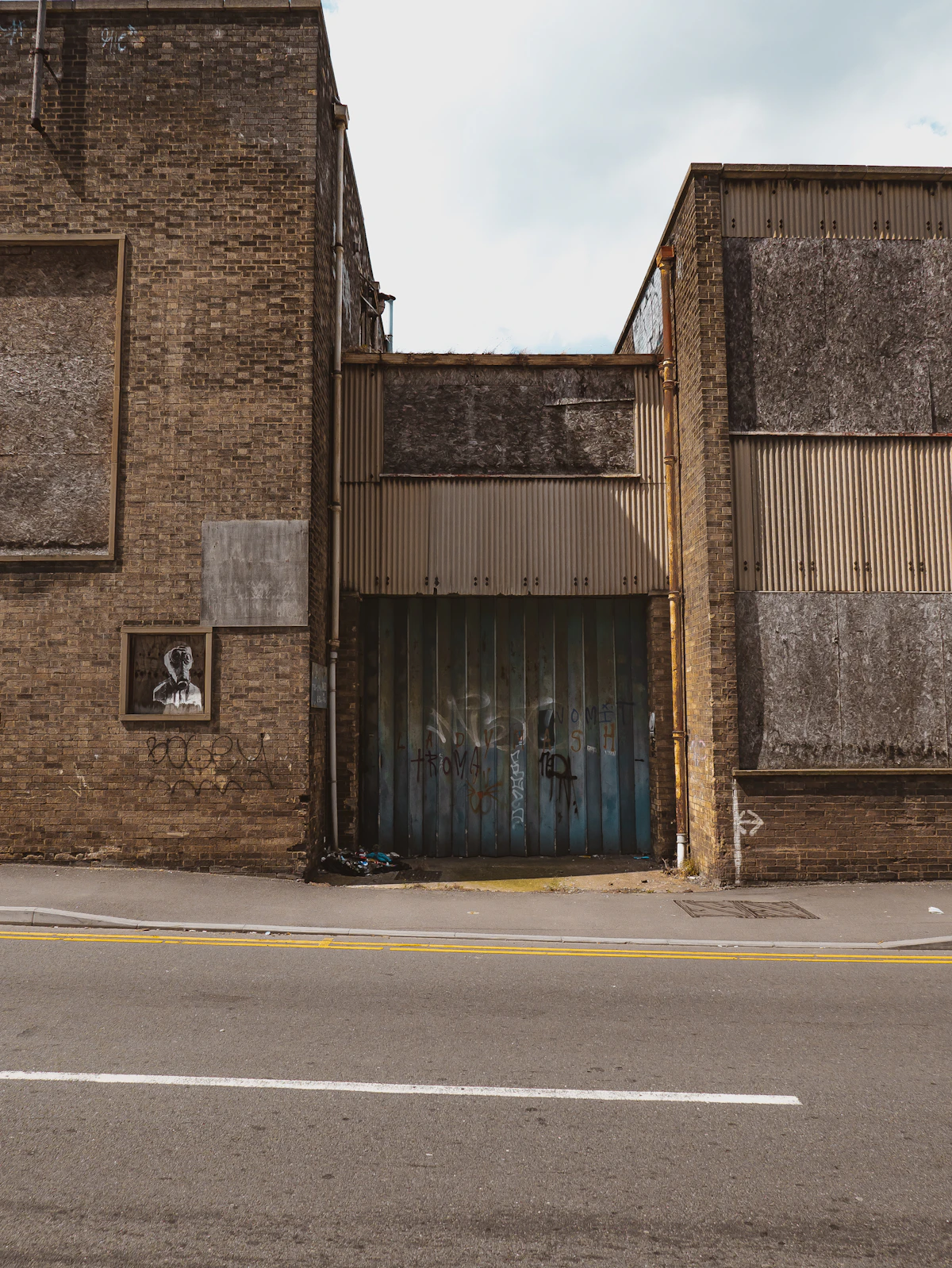 Multi-tenant industrial building with rolling steel service doors along the street frontage