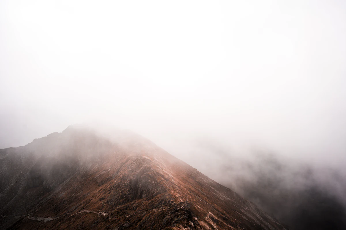 A rocky ridge near the Wildseeloder disappearing into thick fog