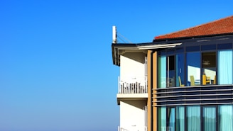 A well-maintained residential building managed by Tucson Asset Group under clear blue skies.