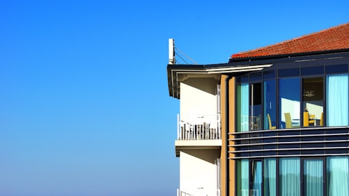 A well-maintained residential building managed by Tucson Asset Group under clear blue skies.