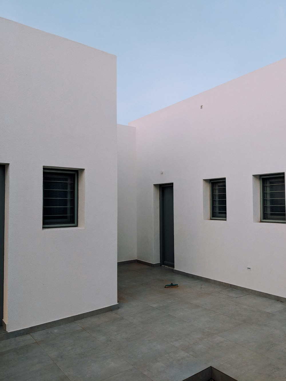 concrete building with doors and windows during day