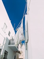 A bright, minimalistic laundry room with breezy clean sheets drying on a line.