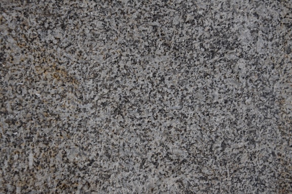 Photo of a polished granite countertop with natural light highlighting its texture