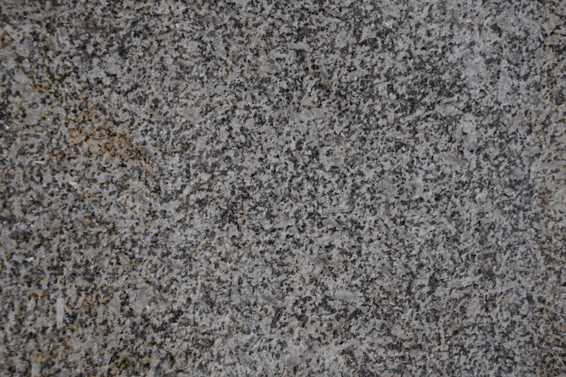 Close-up of a sleek quartz countertop with a subtle veined texture in a modern kitchen setting.
