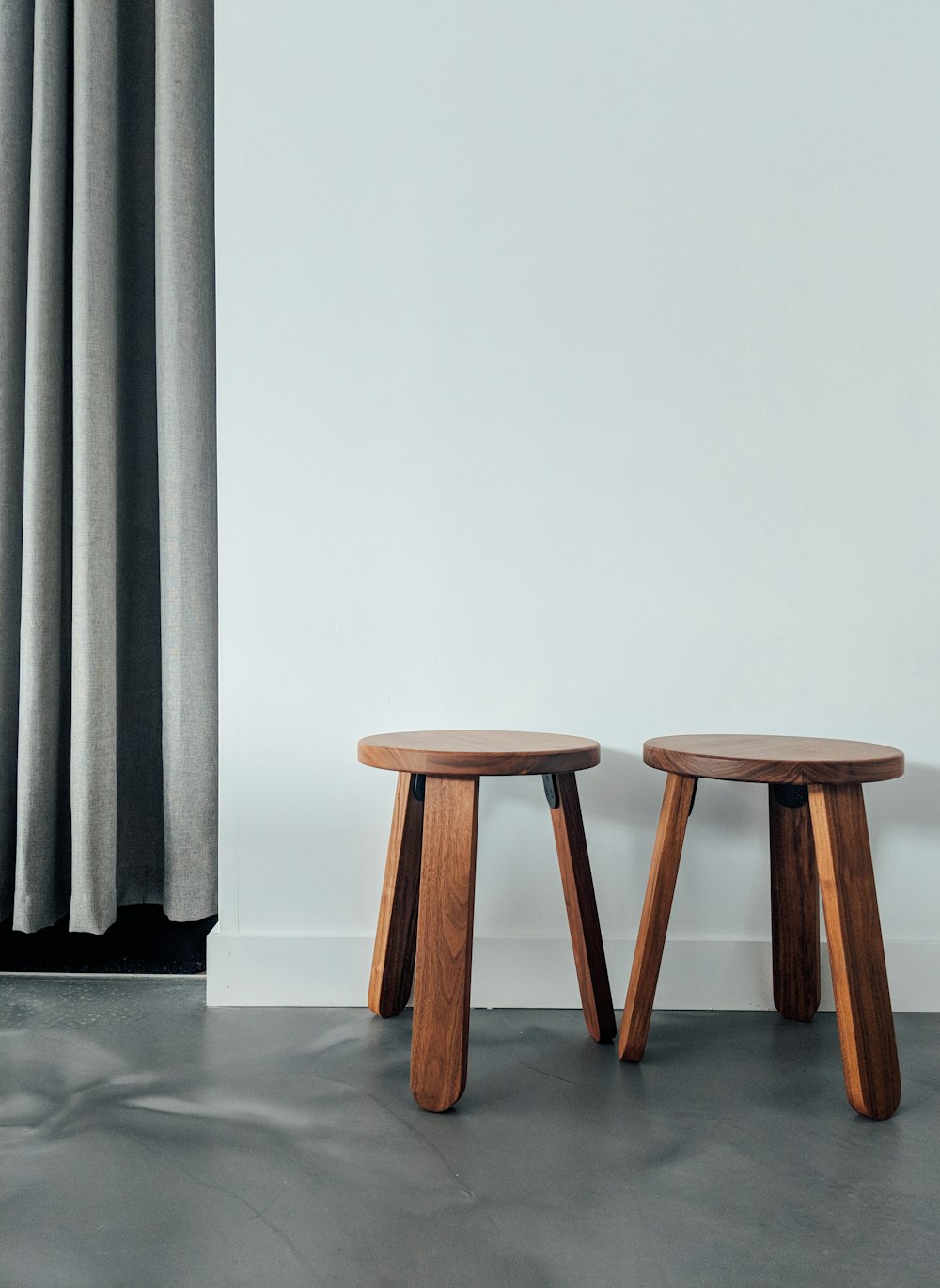 two brown wooden stools