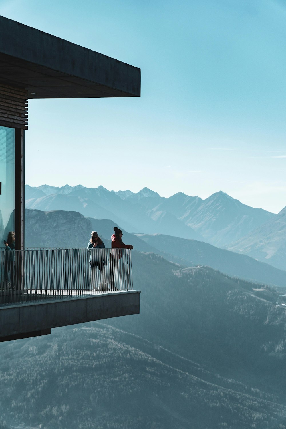 women standing on porch on cliff