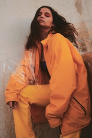woman leaning beside wall