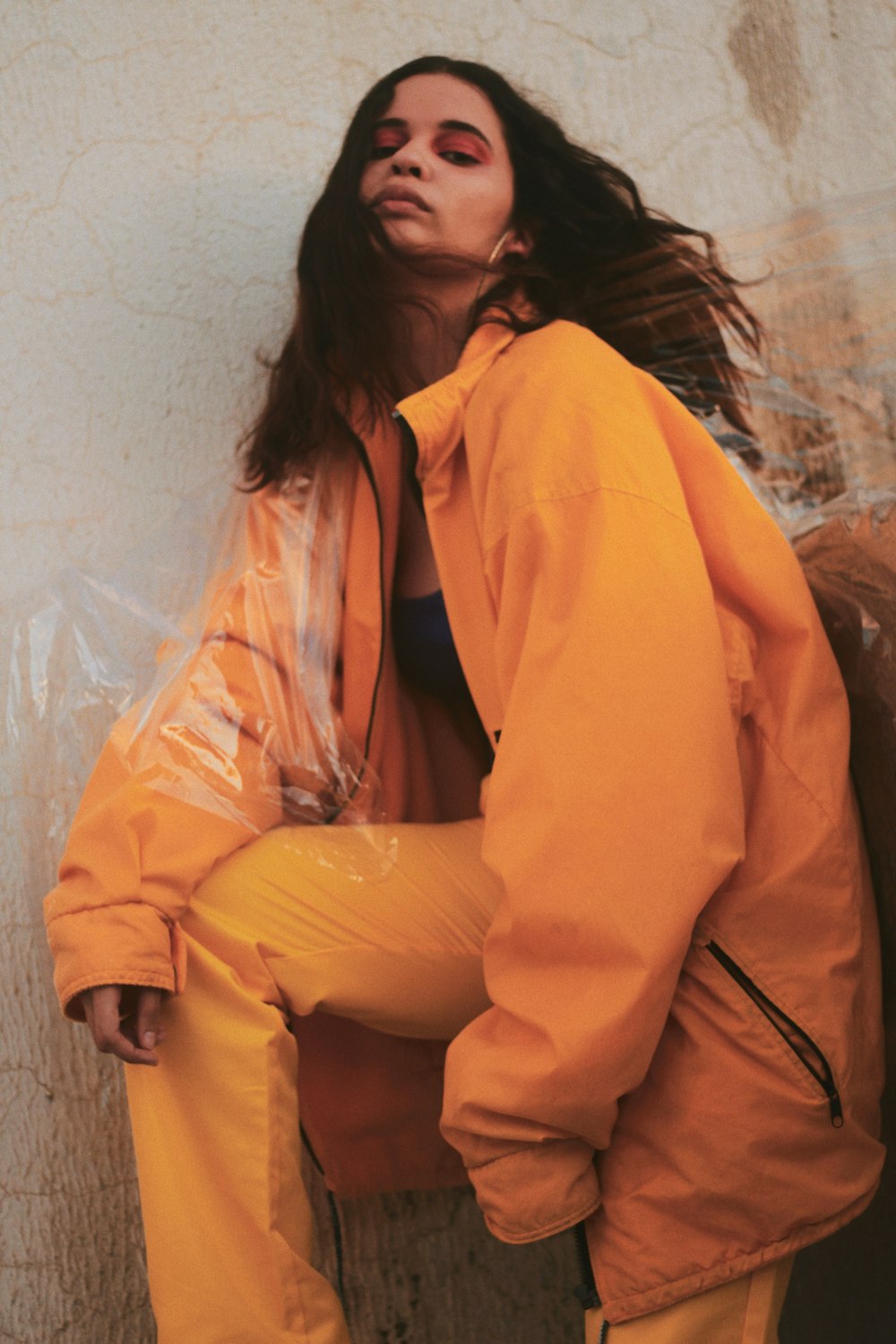 woman leaning beside wall