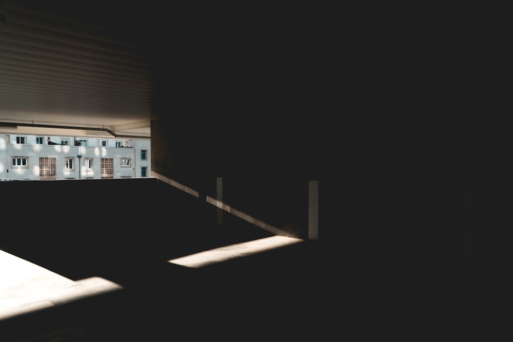 una vista de un edificio a través de una ventana en una habitación oscura