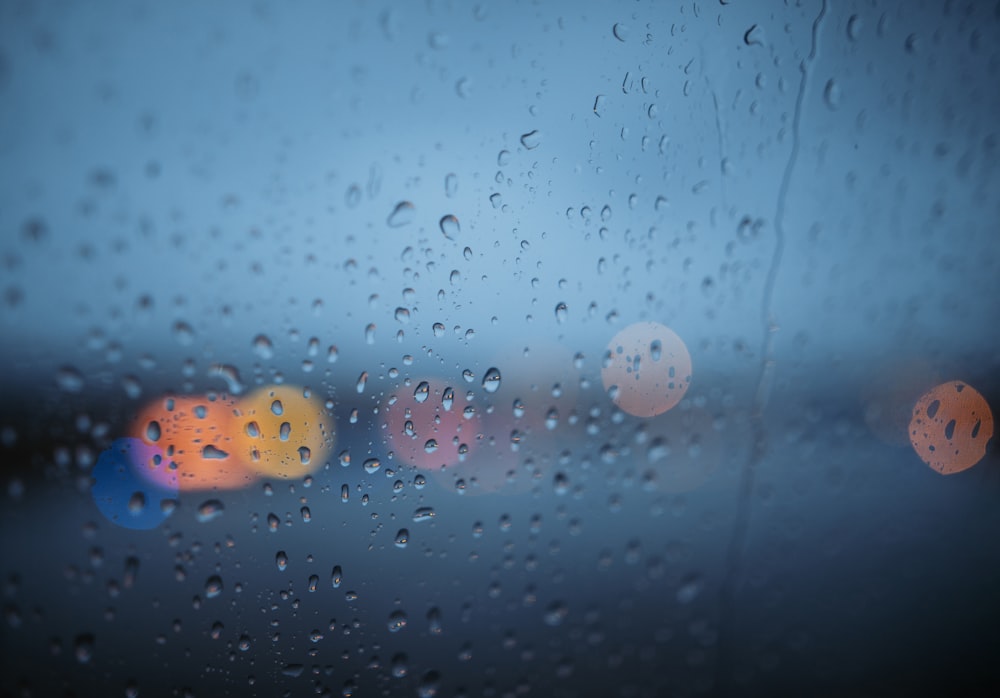 closeup and bokeh photography of water drops on glass