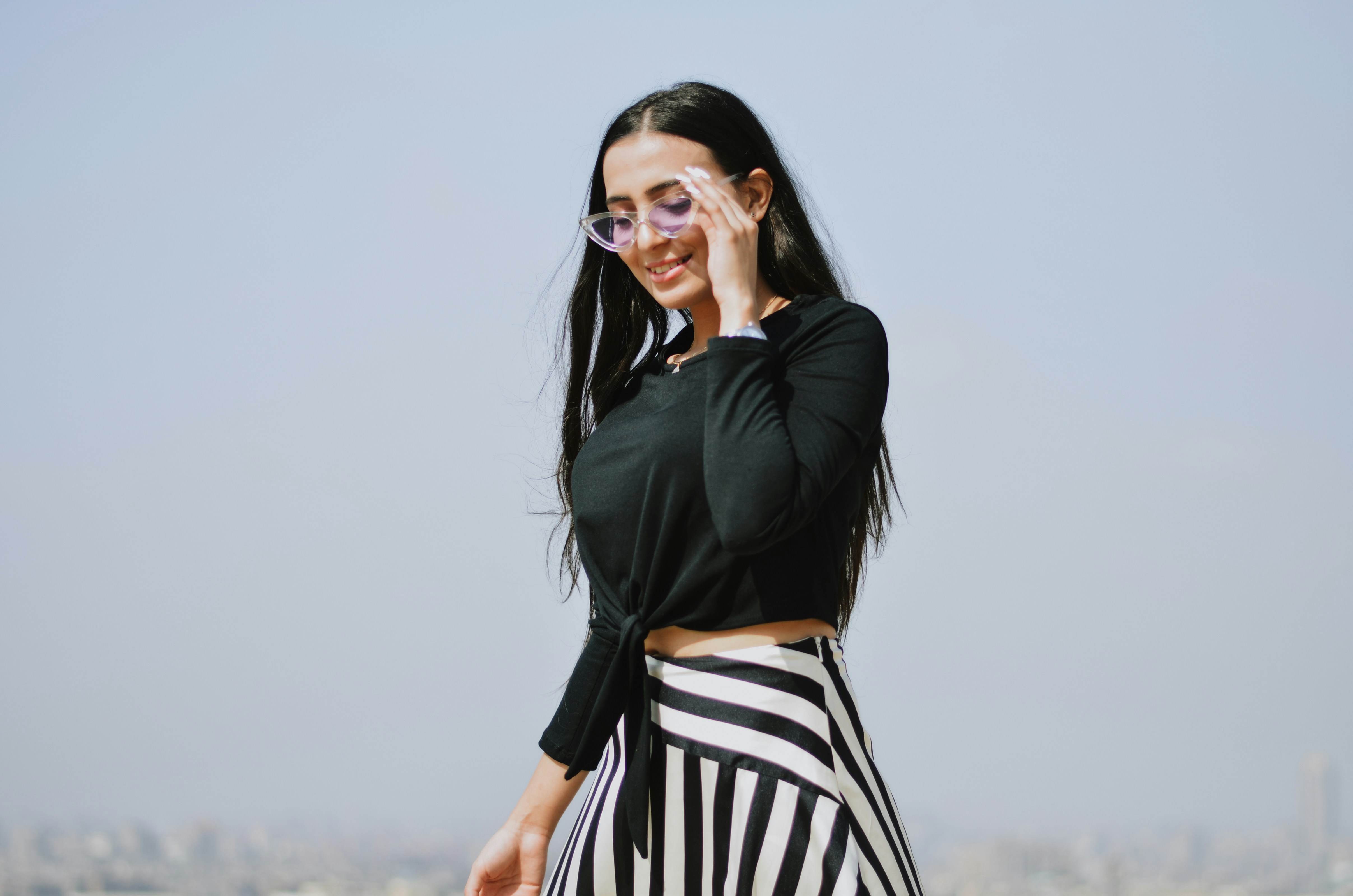 Woman In Black Crop Top And Black And White Striped Skirt Photo