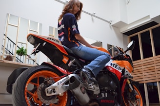 Portrait of Ana Clara, founder of Outlap Journalism, in a cozy editorial studio surrounded by motorsport memorabilia.