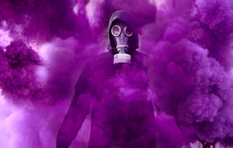 person in black gas mask under purple fog