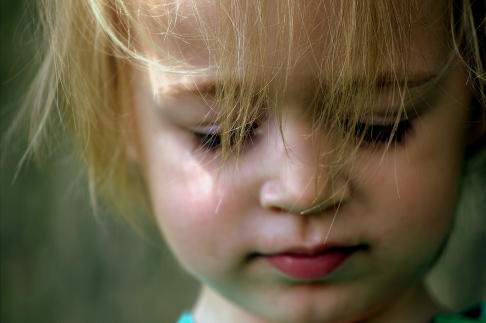 blonde haired toddler looking down