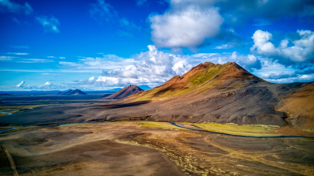 brown and green mountain range under clear blue sky