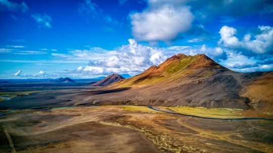 brown and green mountain range under clear blue sky in Möðrudalsleið Iceland