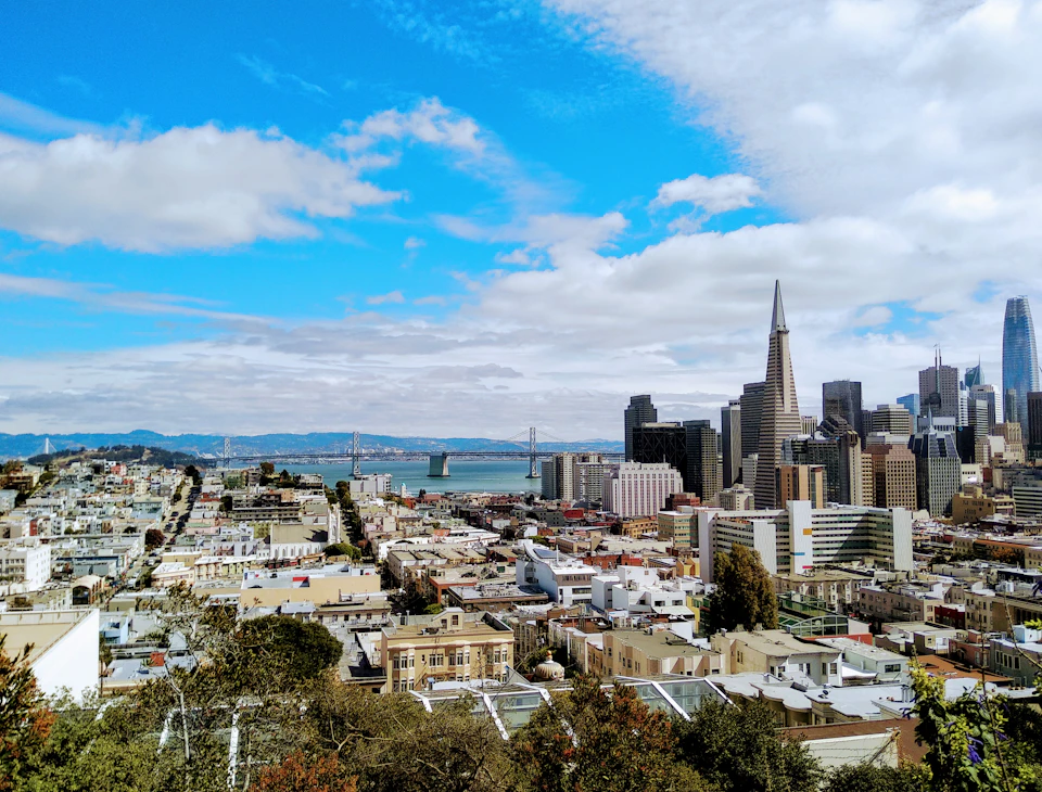 Golden Gate Bridge spans across San Francisco Bay Area's cityscape with clear blue sky