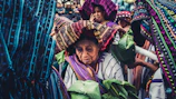 A cultural event scene highlighting traditional Ewi attire with rich colors.