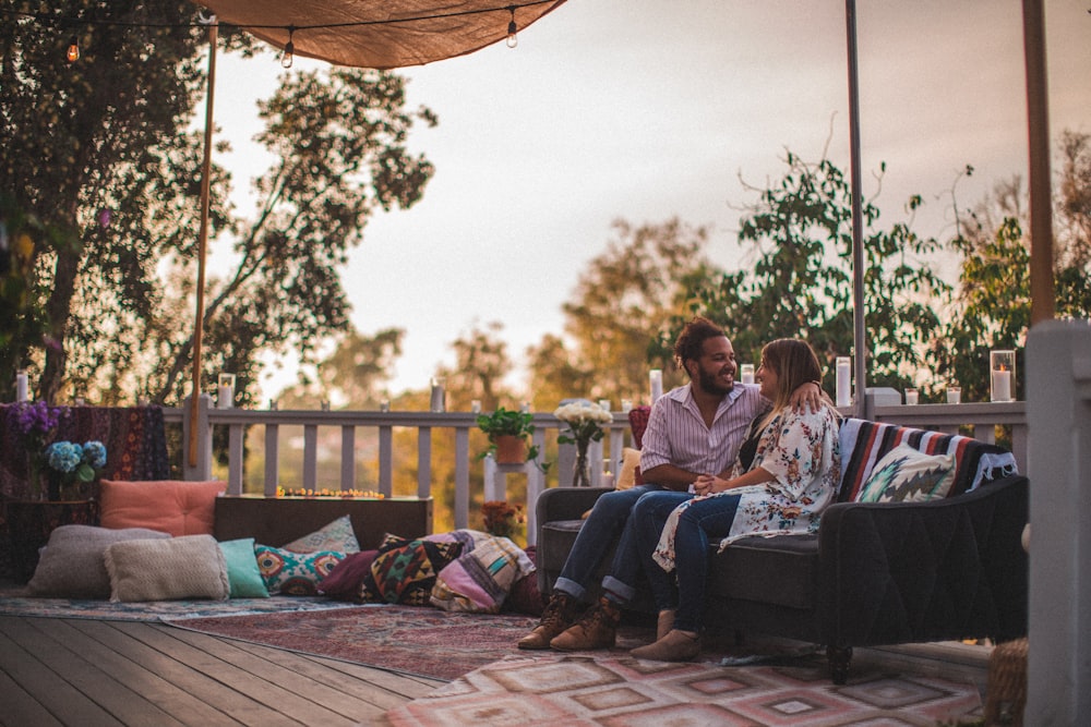 man and woman sitting on bench during golden hour