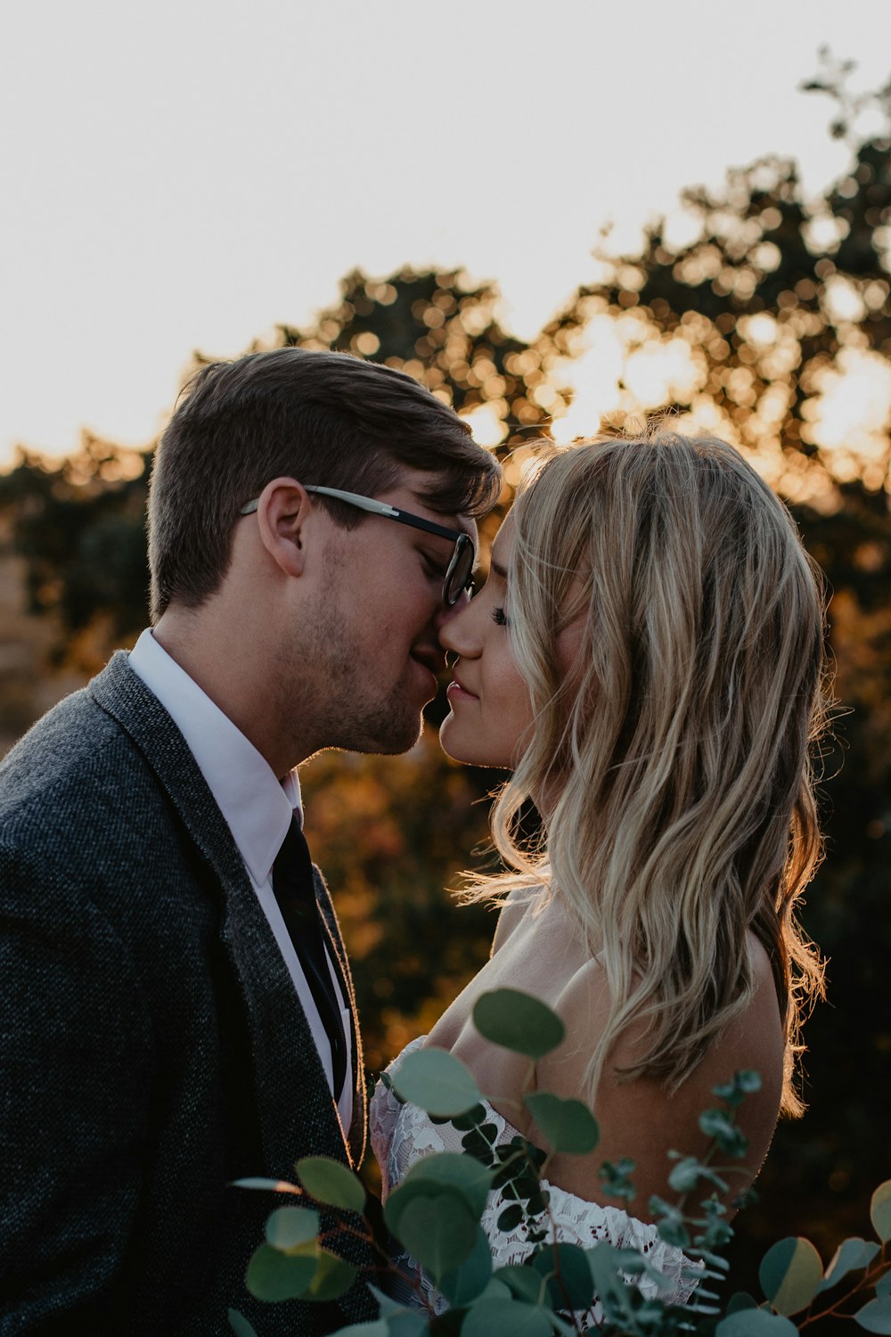 couple kissing wearing dress and suit