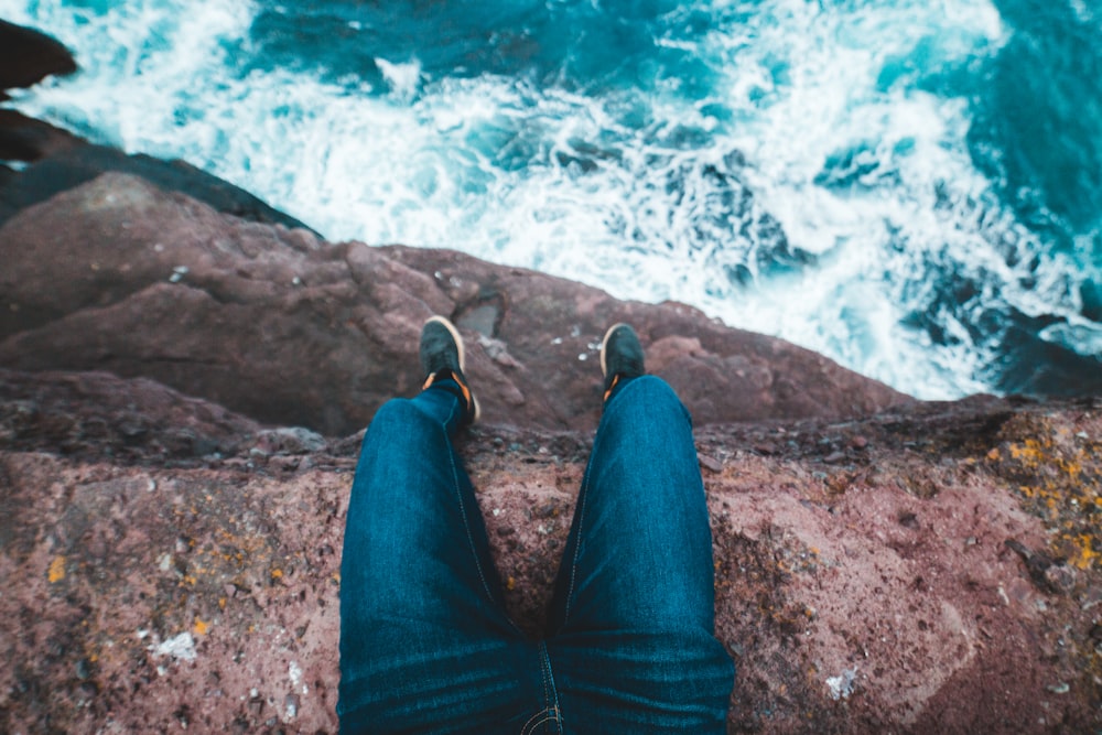 person sitting on cliff